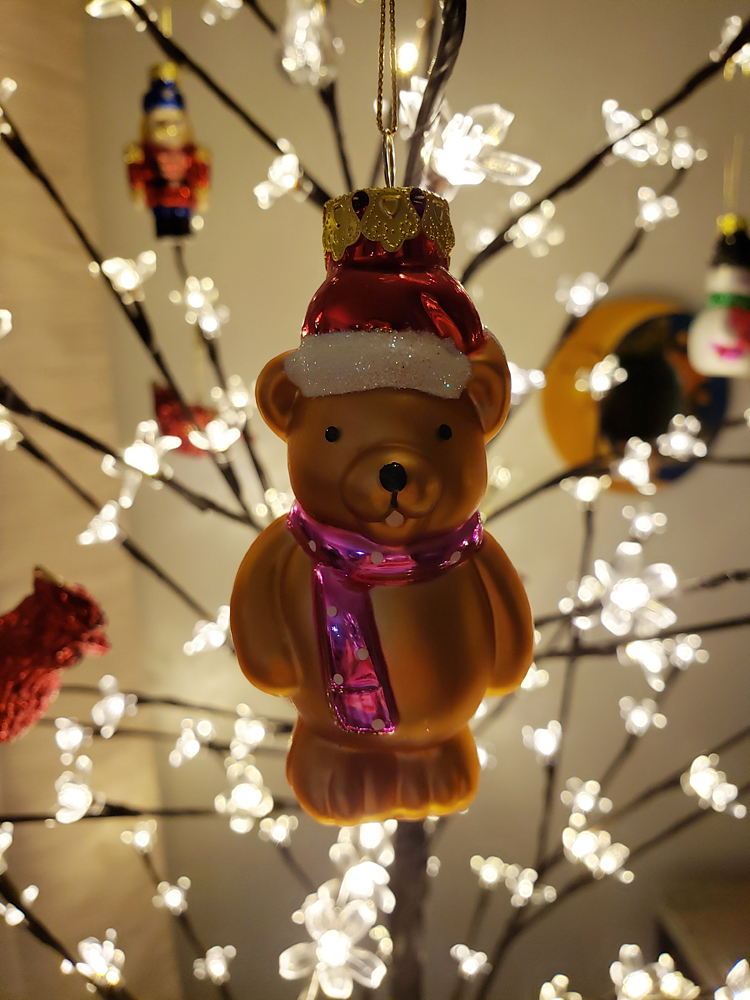A bear ornament in a Christmas tree