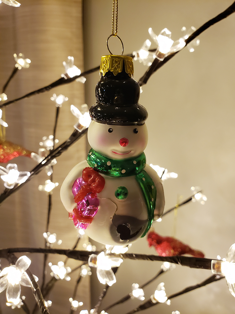 a snowman ornament in a Christmas tree