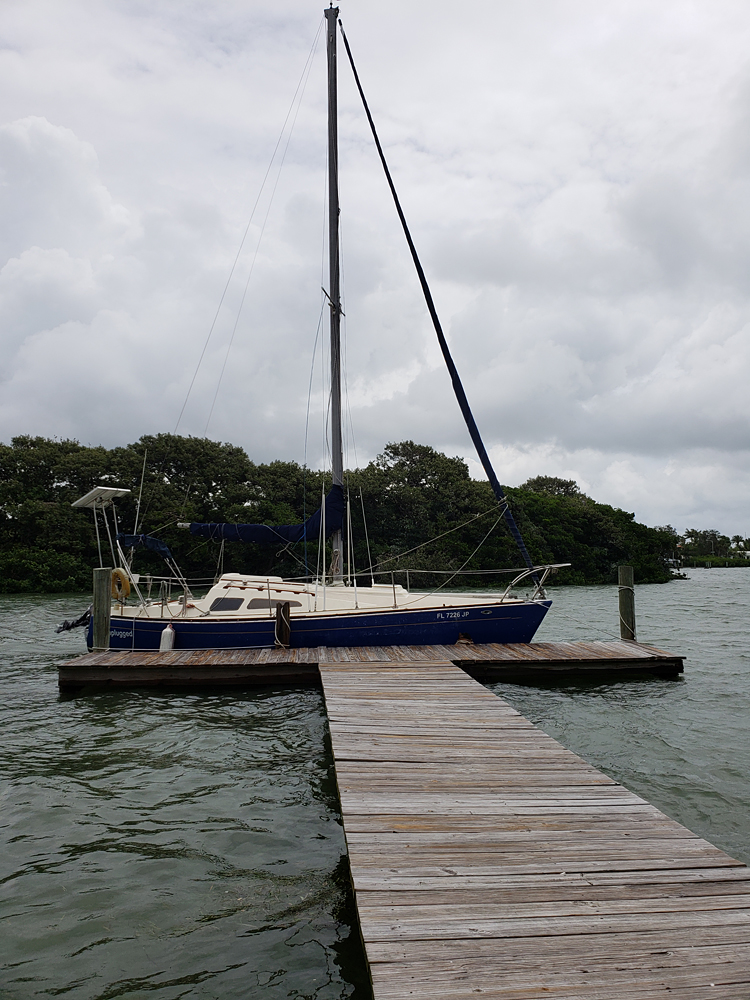 a docked sailboat on an overcast day